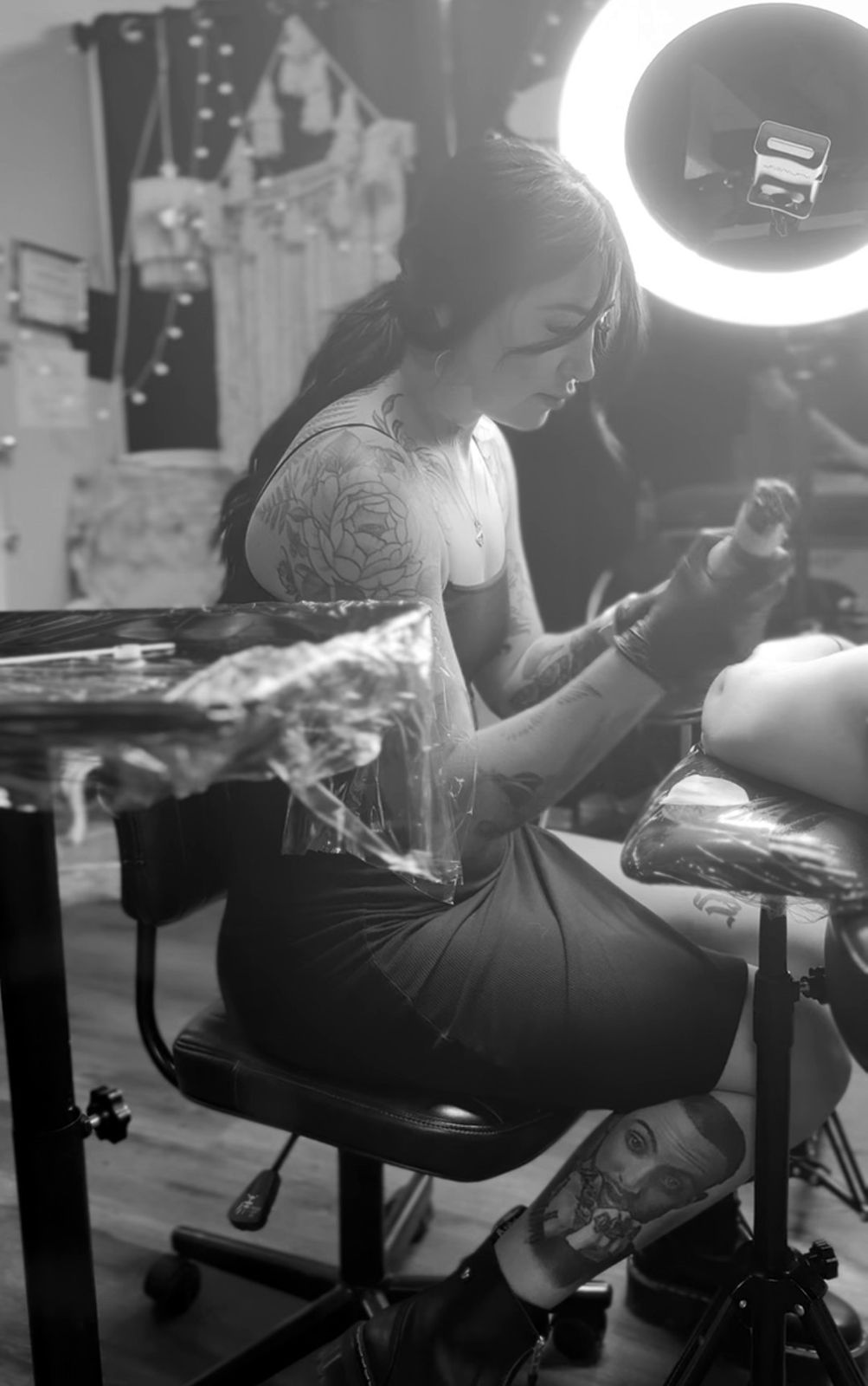 Maddy tattooing a client in the studio